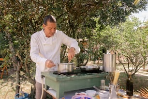 a man cooking food on top of a stove