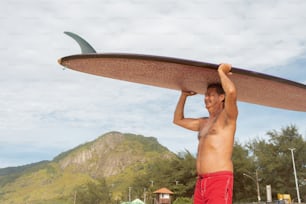 a man holding a surfboard over his head