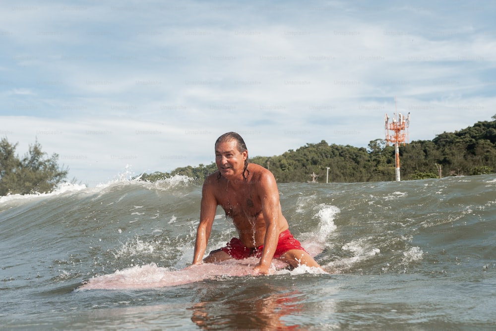 Un hombre montando una tabla de surf en una ola en el océano