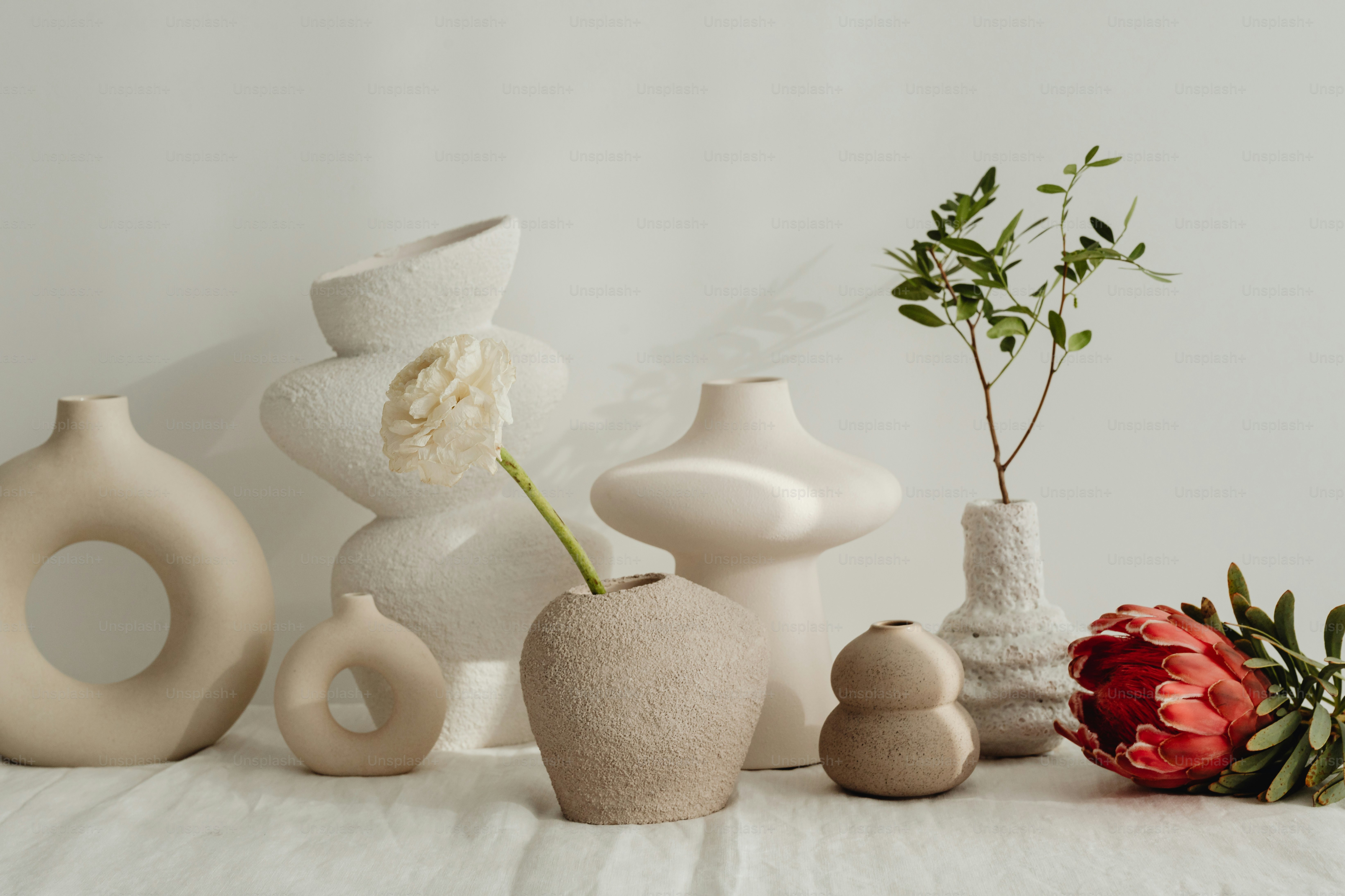 A group of white vases sitting on top of a table photo – Flowers Image ...