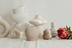 a group of white vases sitting on top of a table