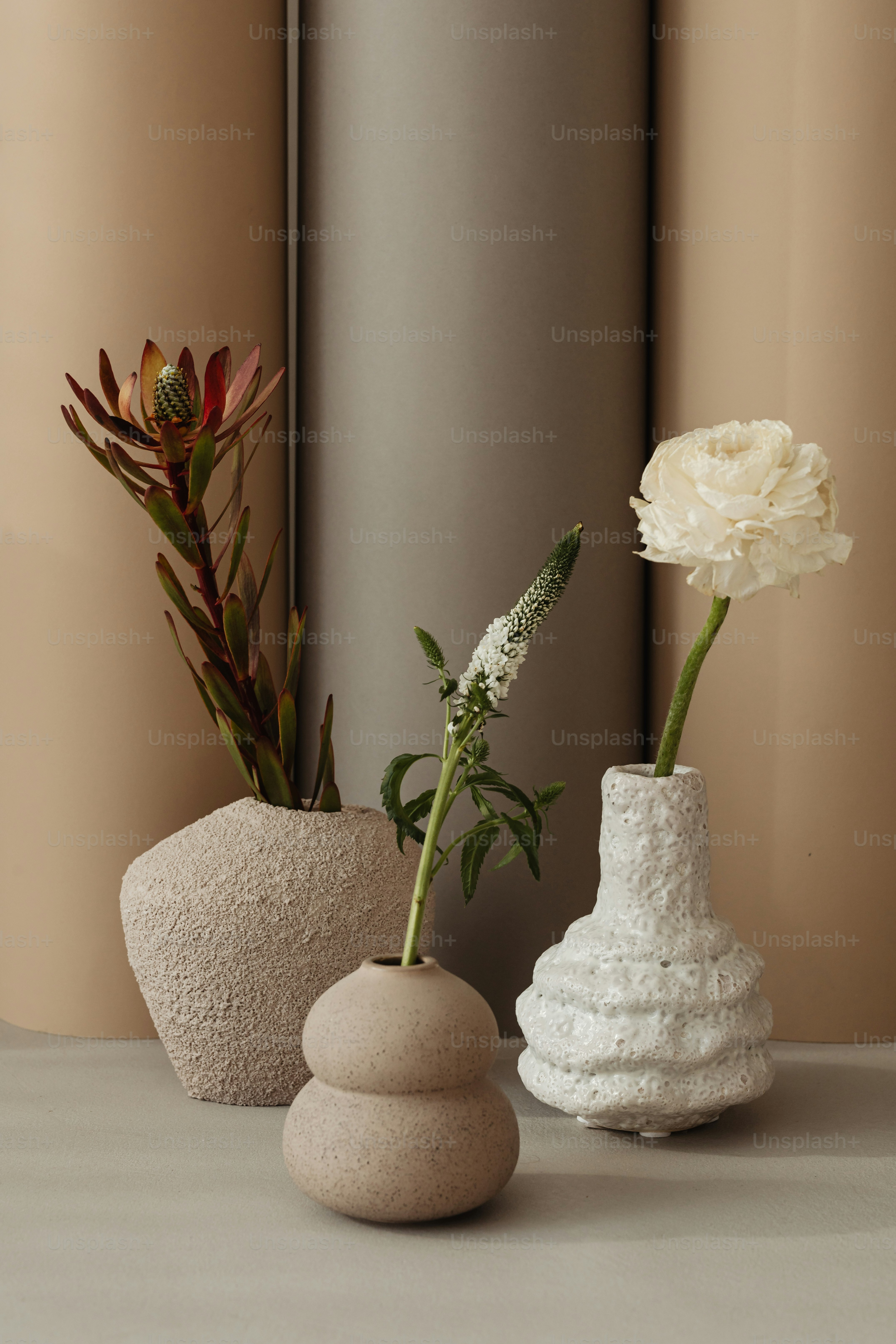 A group of white vases sitting on top of a table photo – Backgrounds ...