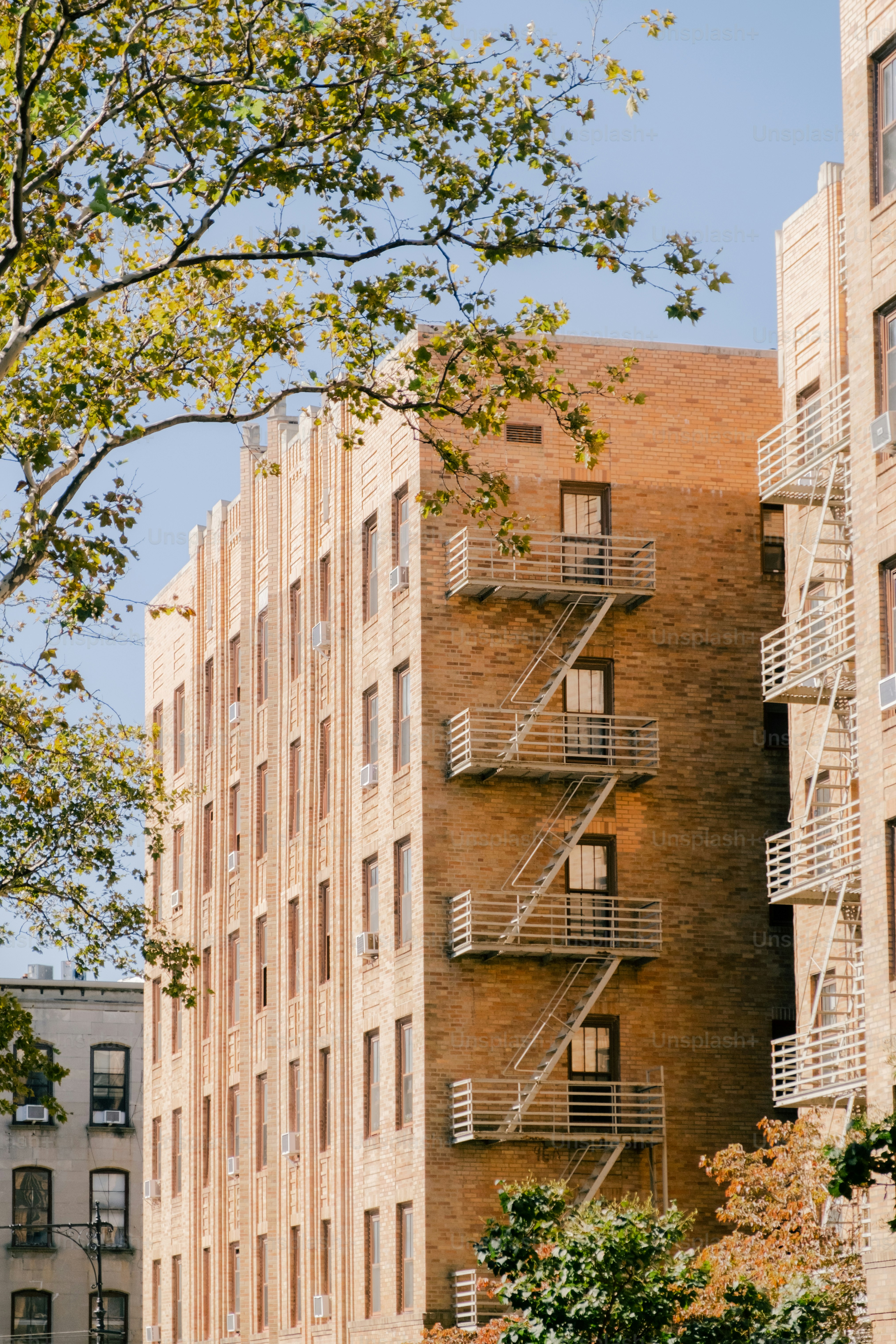 a tall brick building with a fire escape