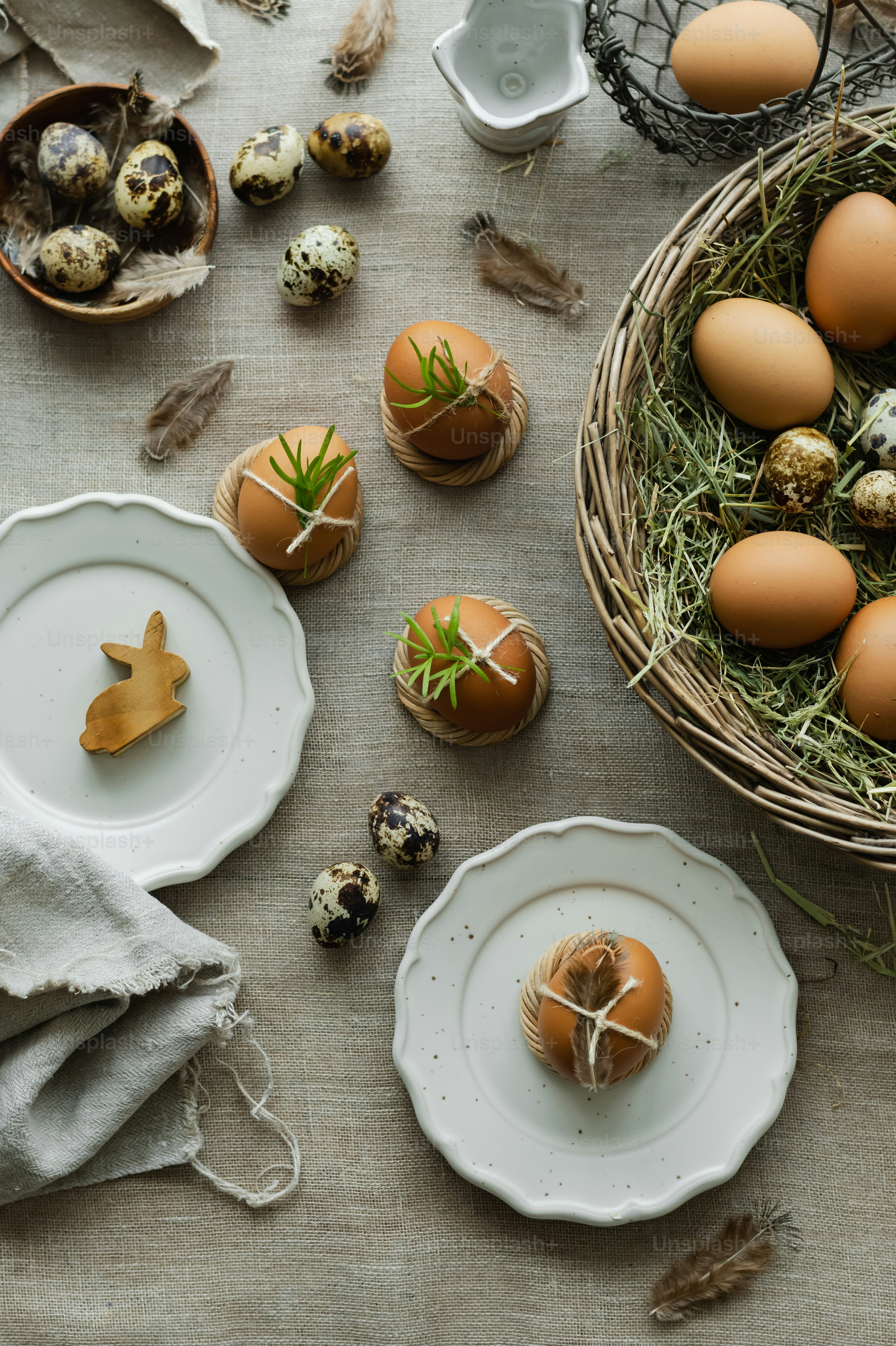 a table topped with plates and bowls filled with eggs