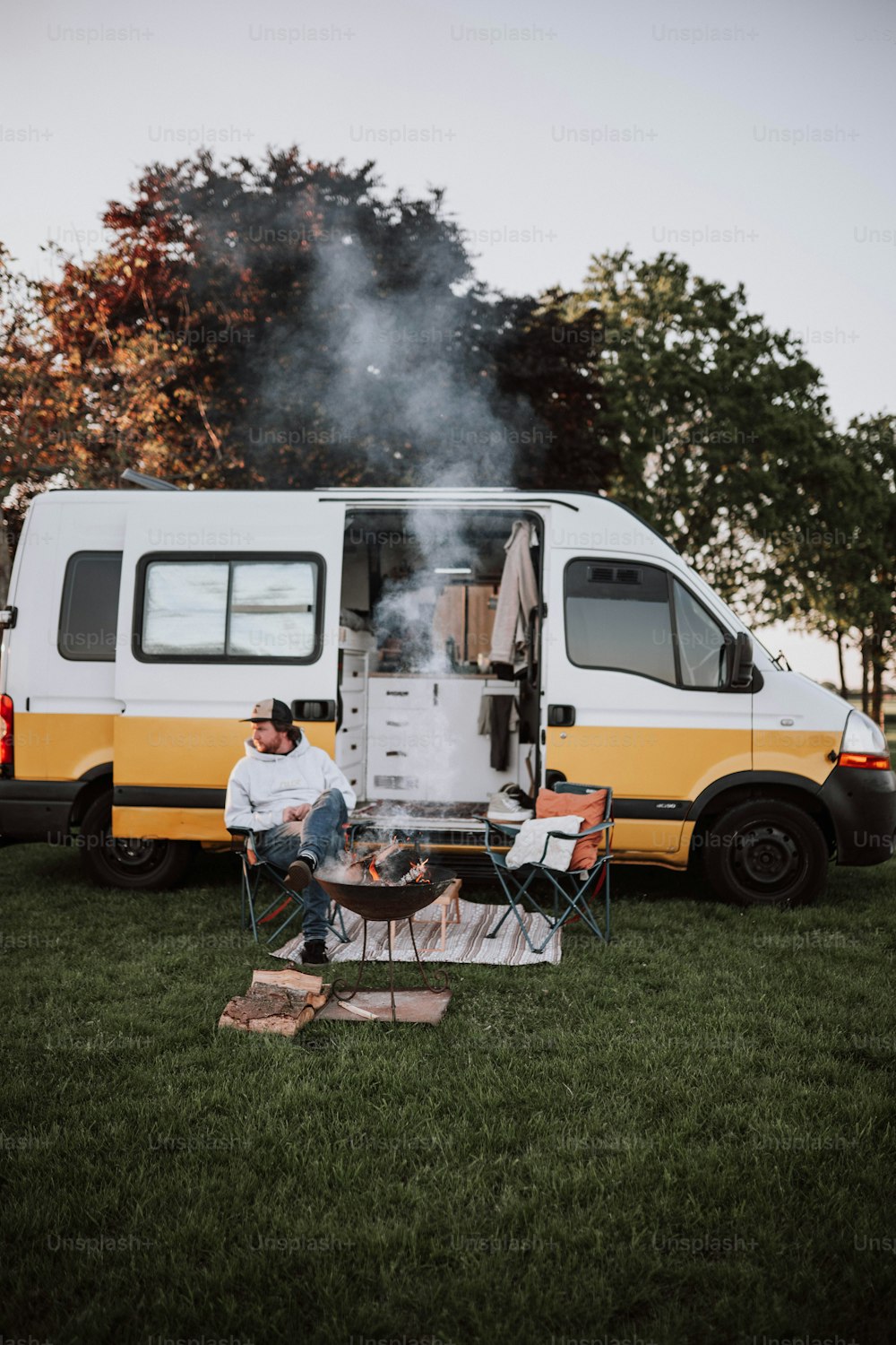 a man sitting at a table in front of a van