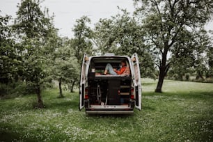 a man sitting in the back of a van