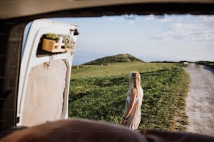 a woman standing in the back of a truck