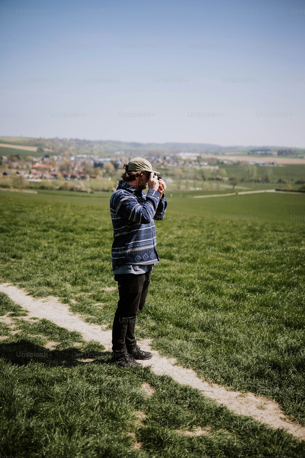 a man standing in a field taking a picture