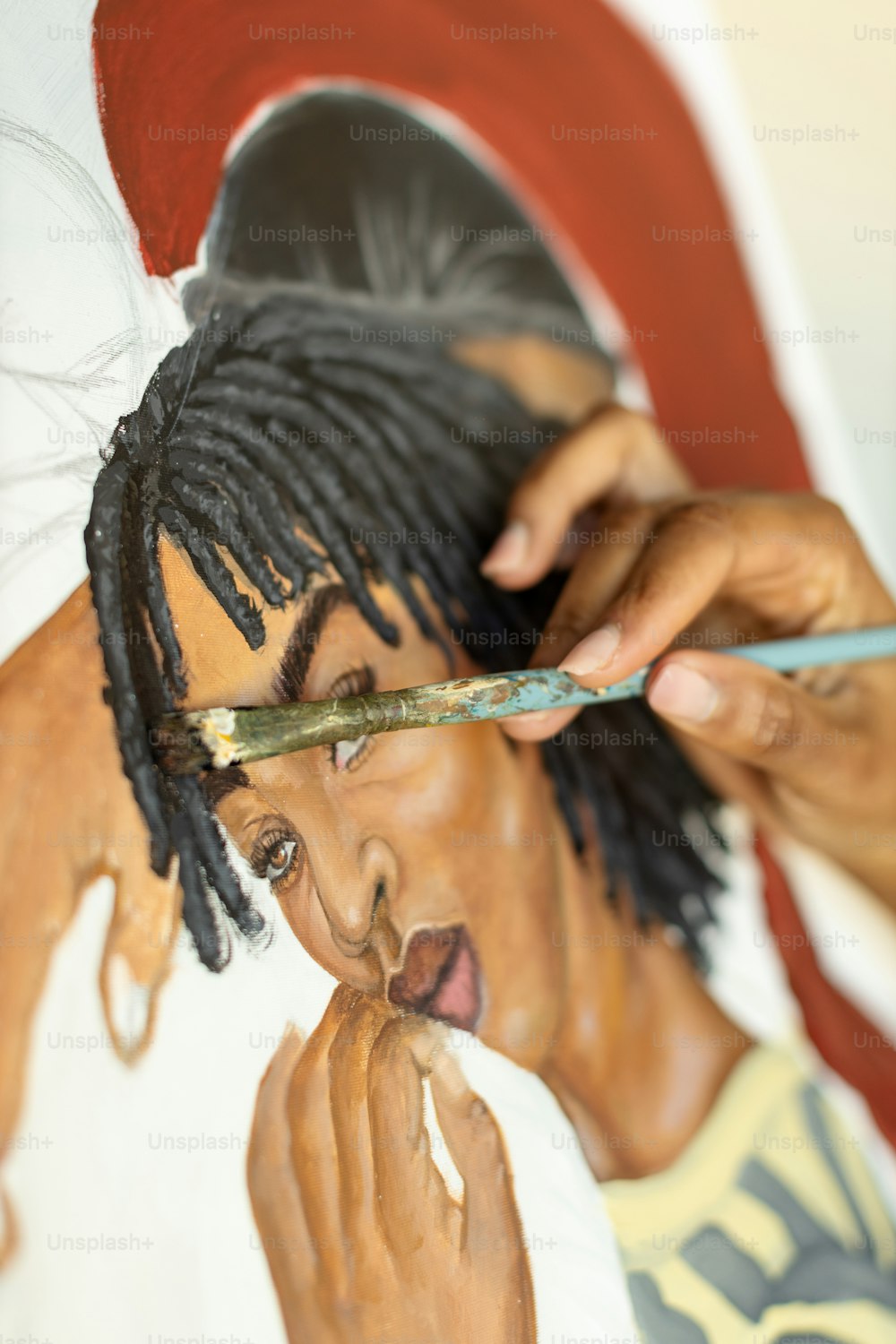 a man with dreadlocks cutting another mans hair