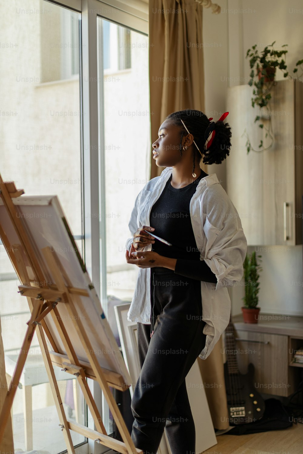 a woman is standing in front of a easel