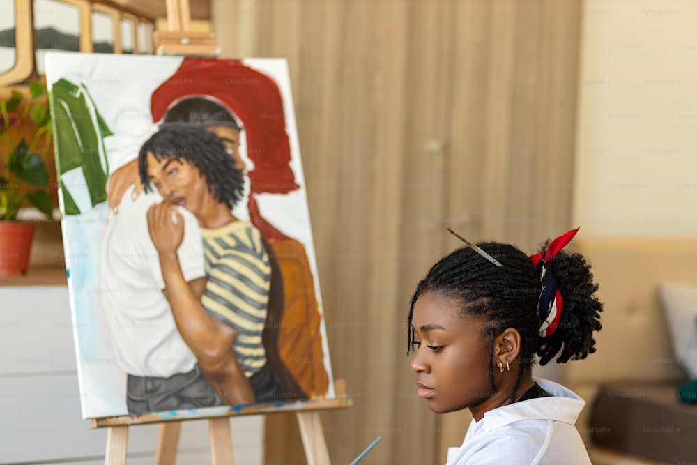 a young girl is painting a picture on a easel
