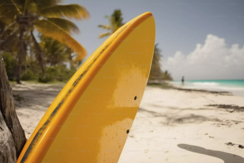a yellow surfboard leaning against a tree on a beach