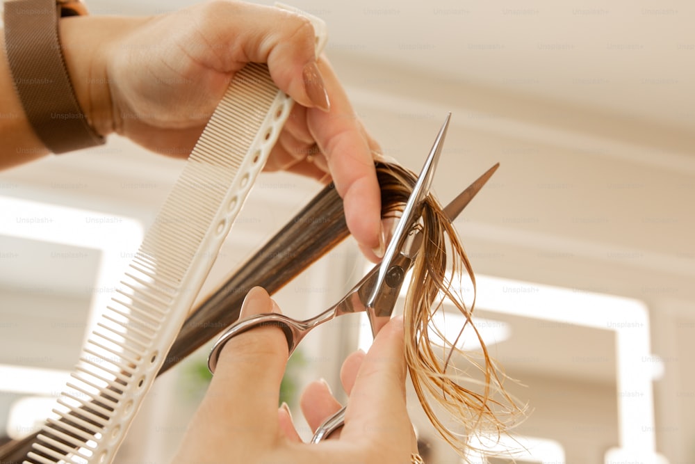 uma mulher está cortando o cabelo com uma tesoura