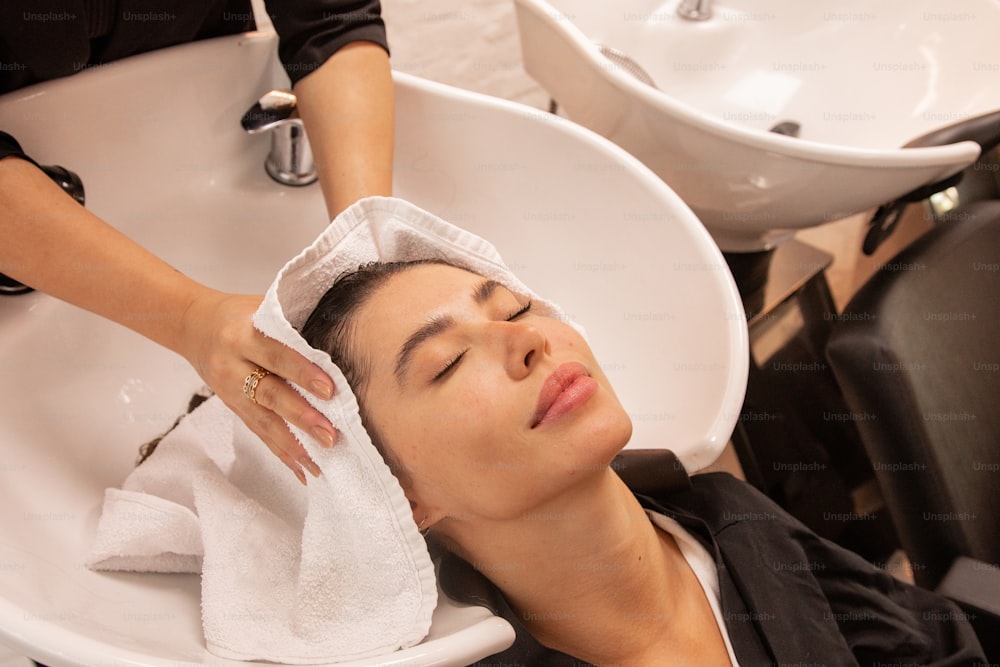 a woman getting her hair washed in a salon