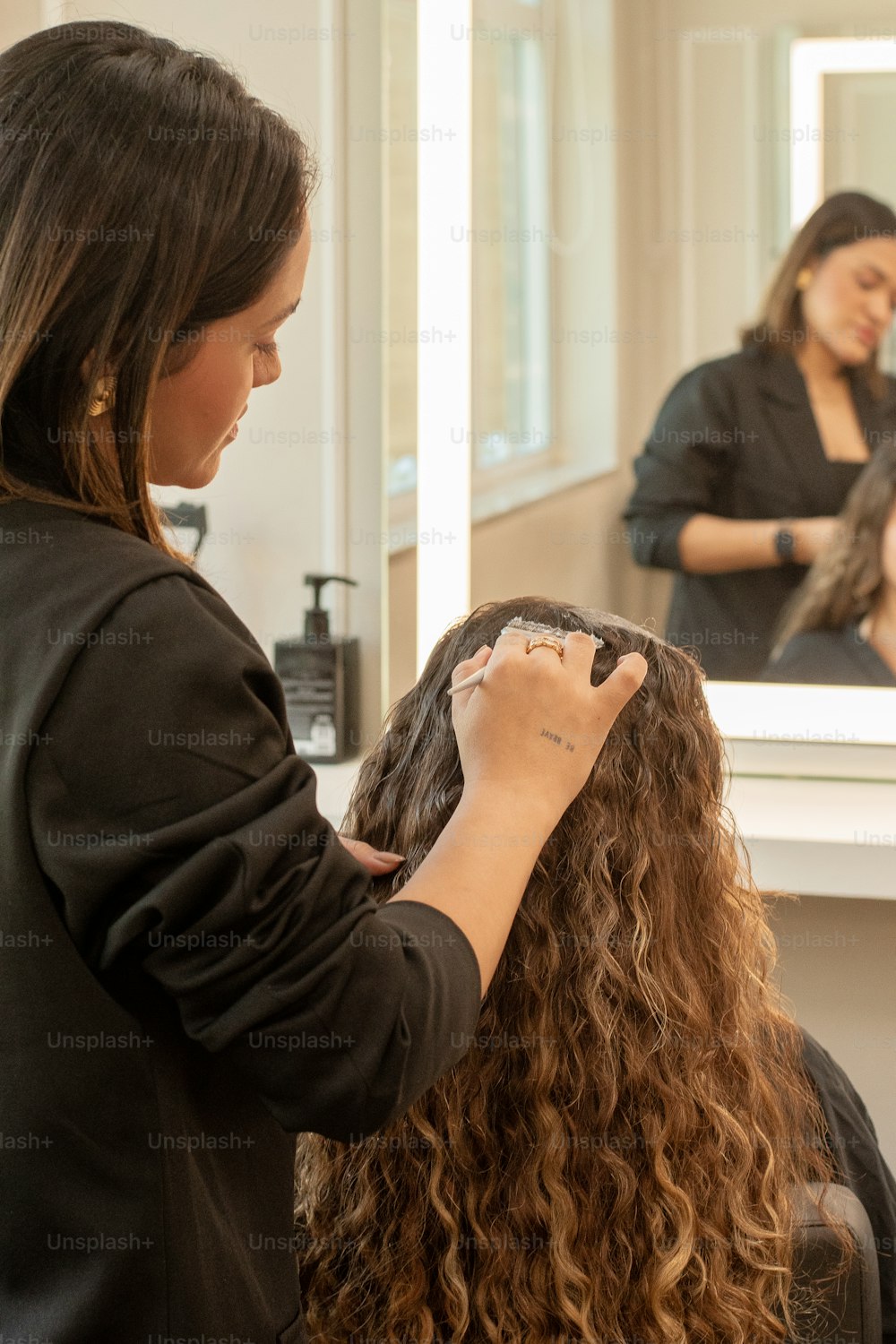 a woman getting her hair done in a salon