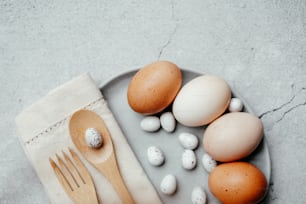 a plate of eggs and a wooden spoon on a table