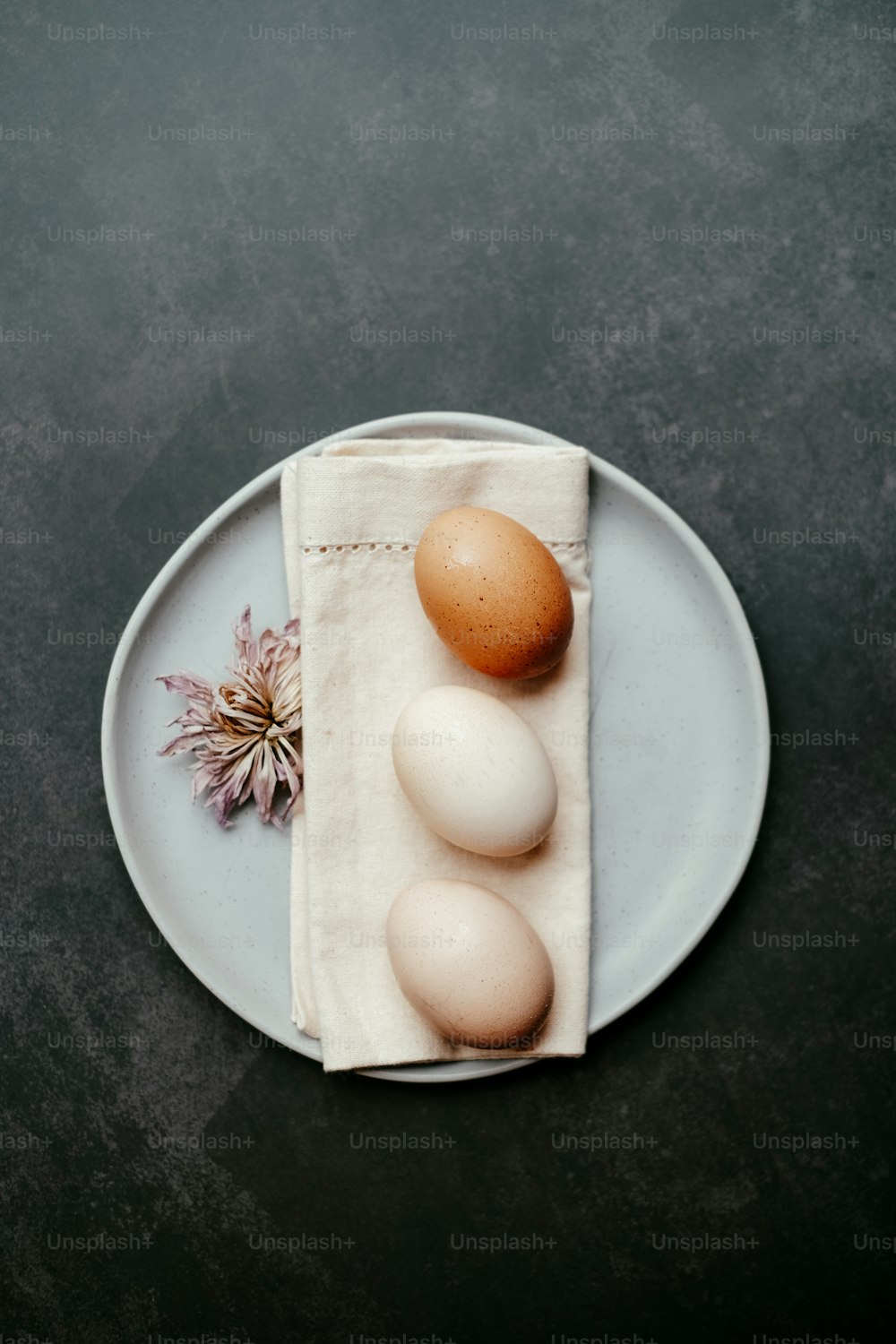 three eggs on a plate with a napkin