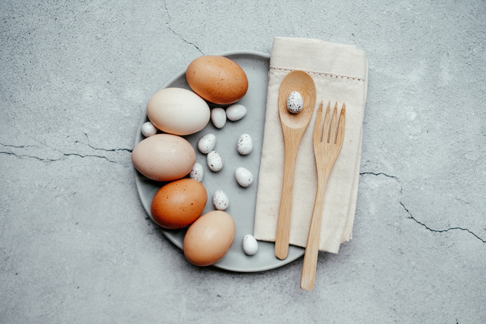 a plate with eggs, a fork and spoon on it