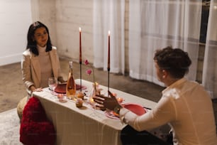 a woman sitting at a table with a man