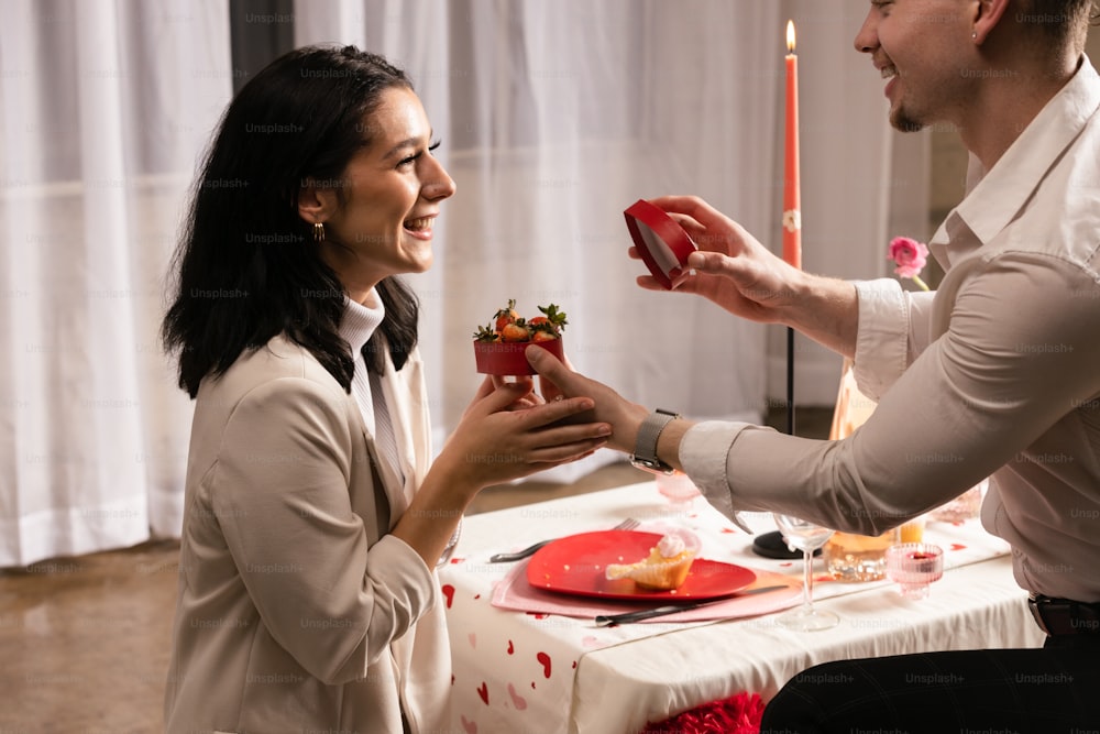 a man and a woman sharing a piece of cake