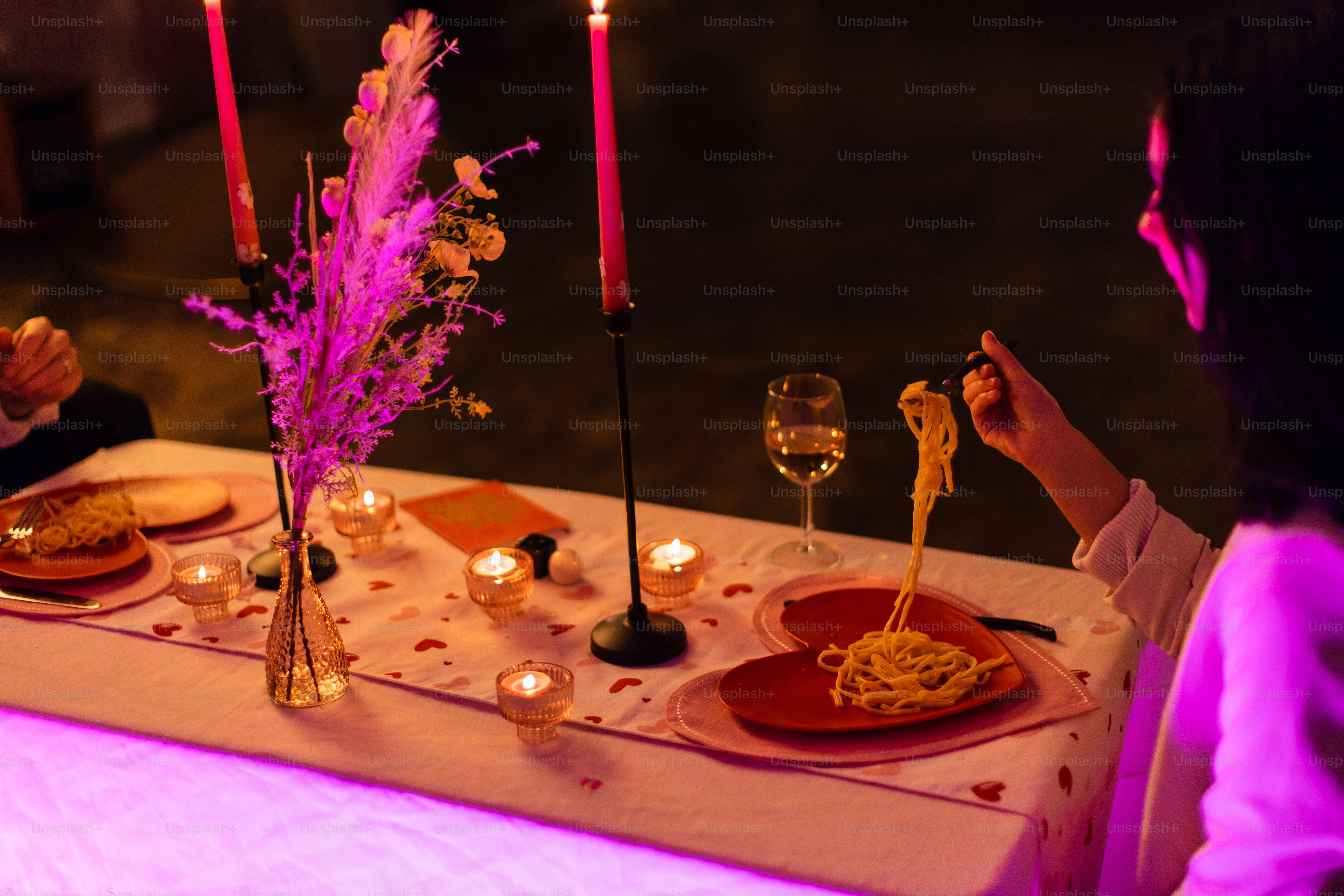 a woman sitting at a table with a plate of food