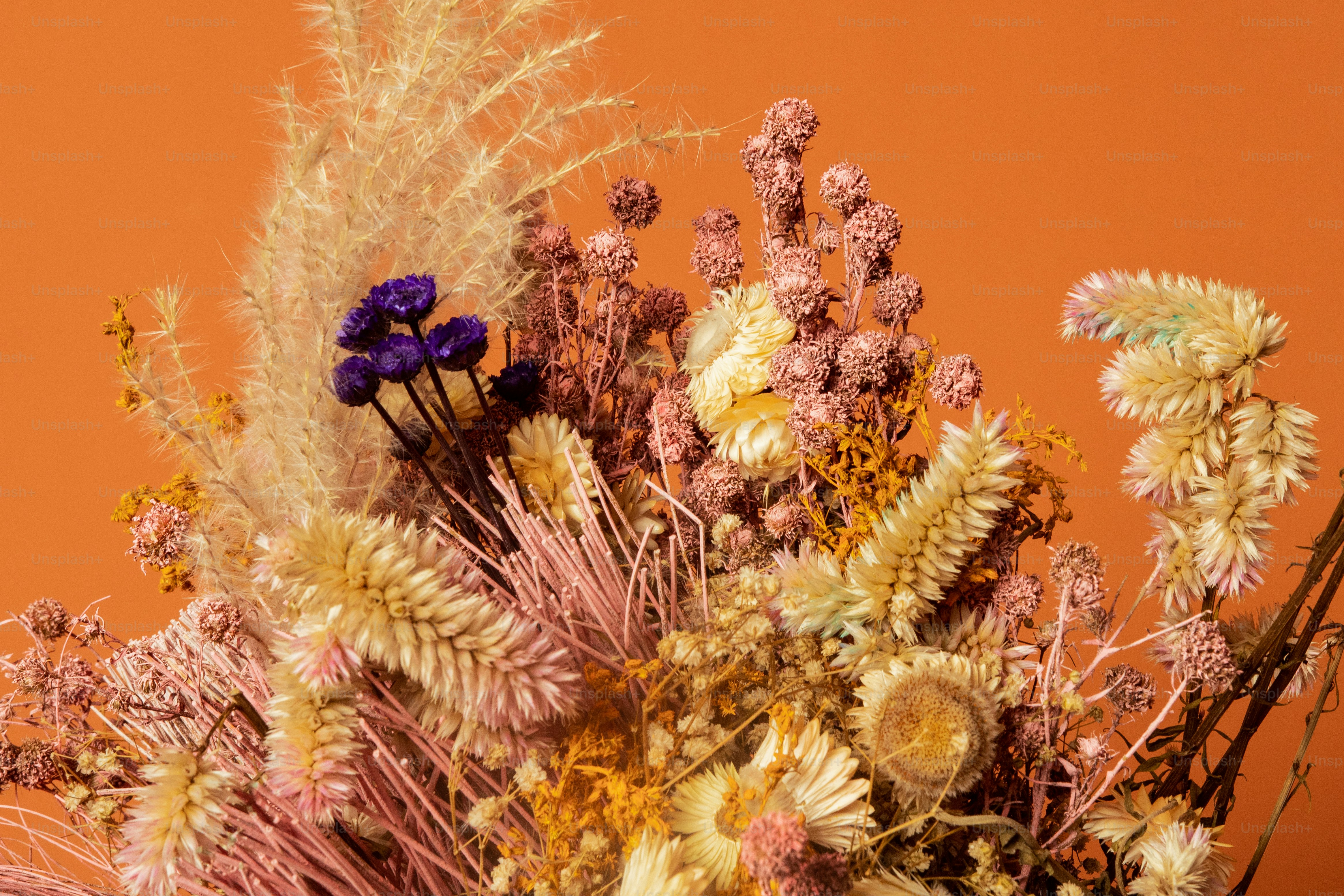 a vase filled with lots of different types of flowers