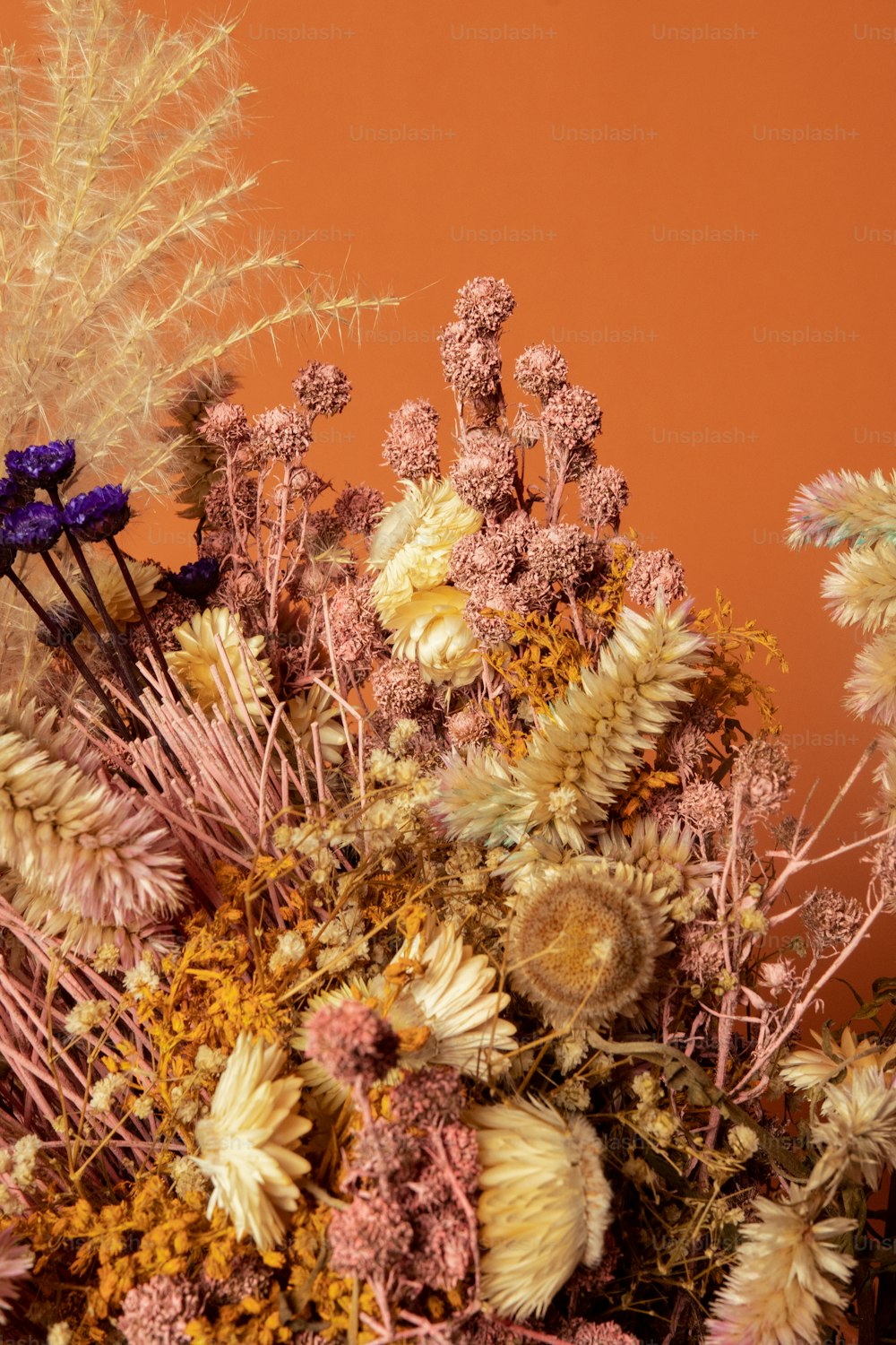 a vase filled with lots of different types of flowers