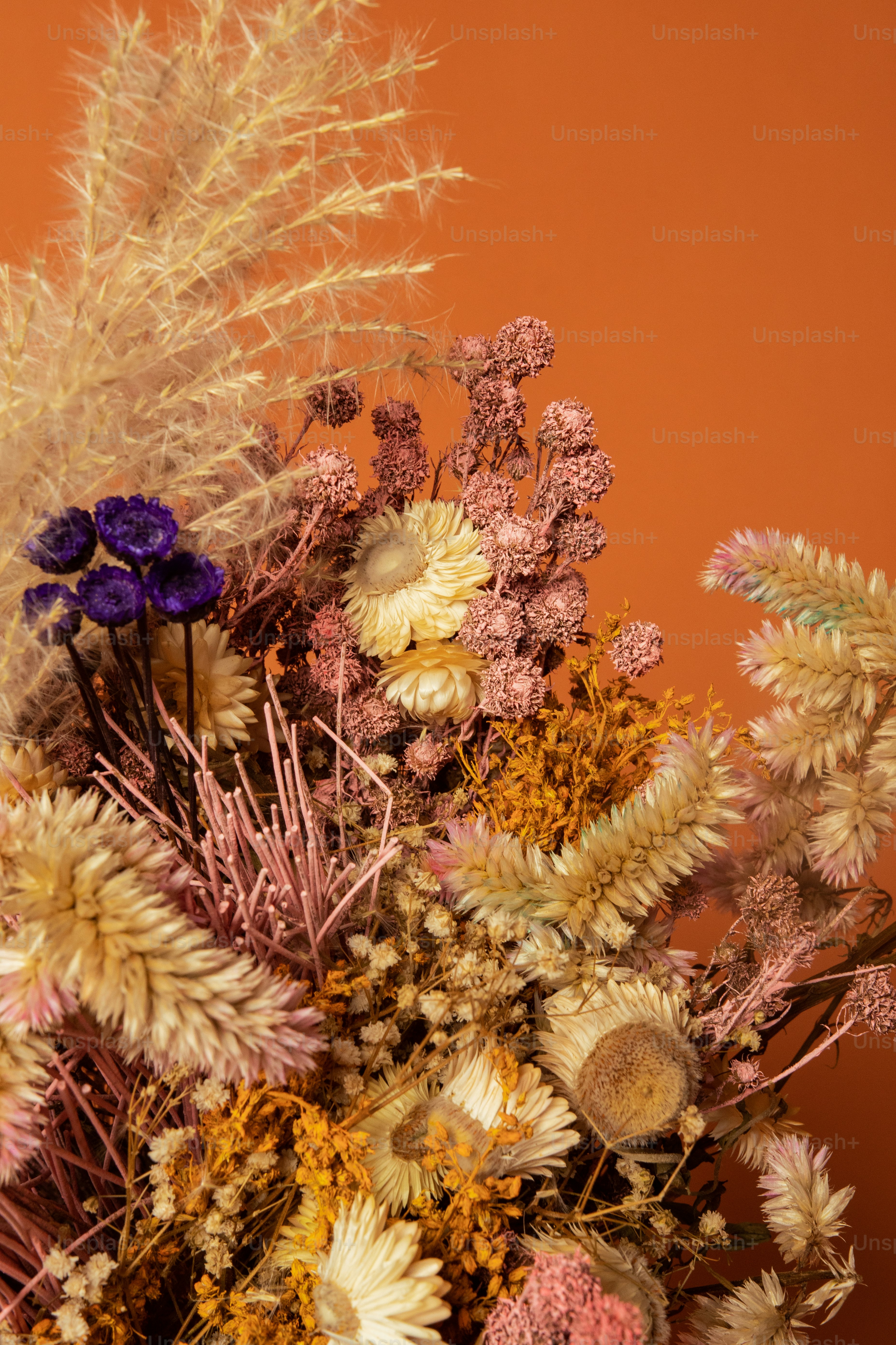 a vase filled with lots of different types of flowers
