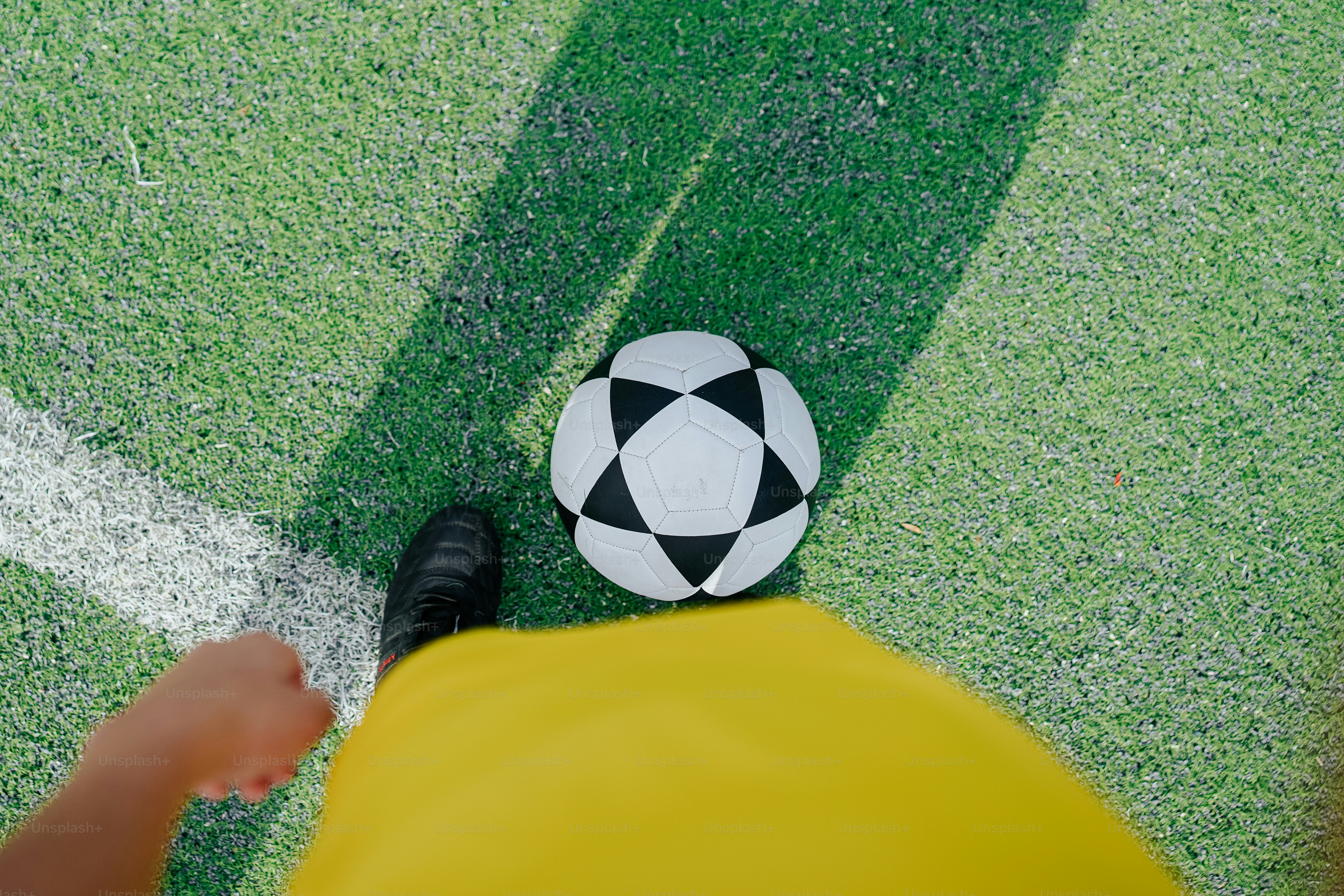 a soccer ball sitting on top of a green field
