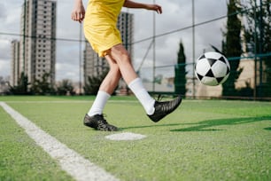 a man kicking a soccer ball on a field