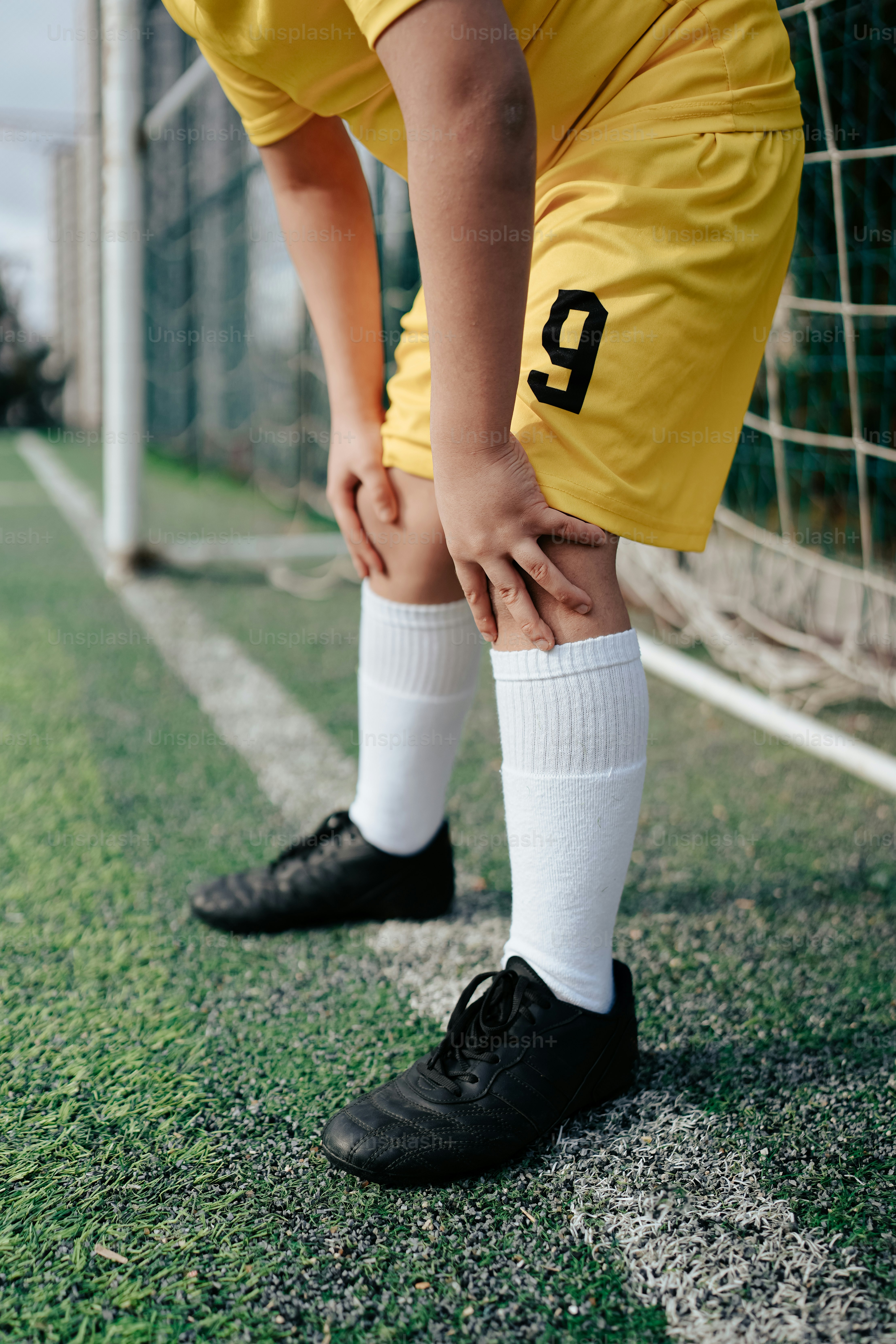 a soccer player with his foot on the net