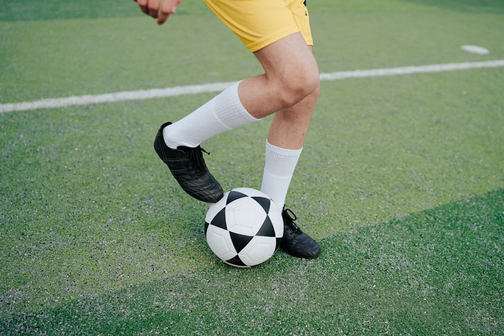 a soccer player with a soccer ball on a field