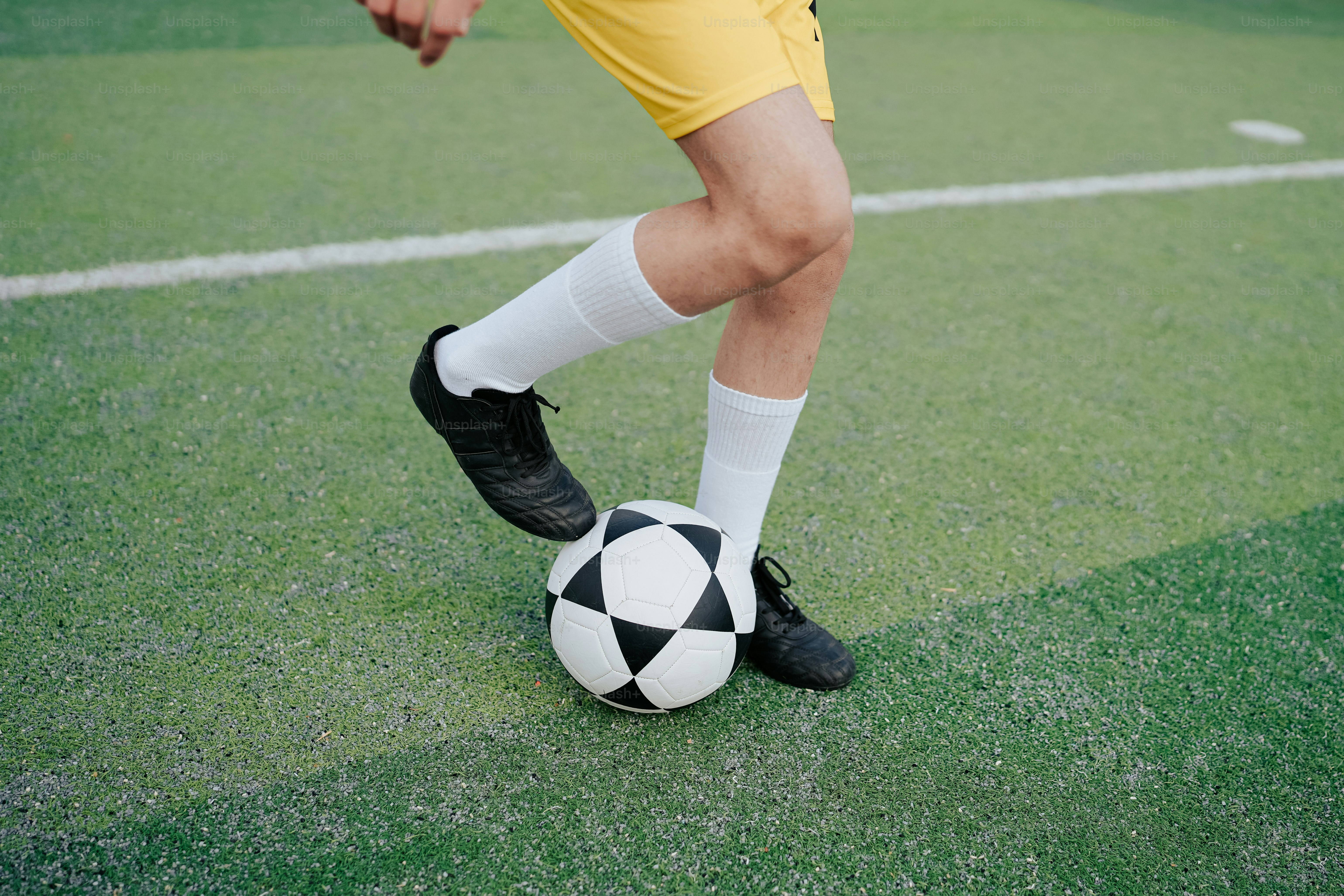 a soccer player with a soccer ball on a field