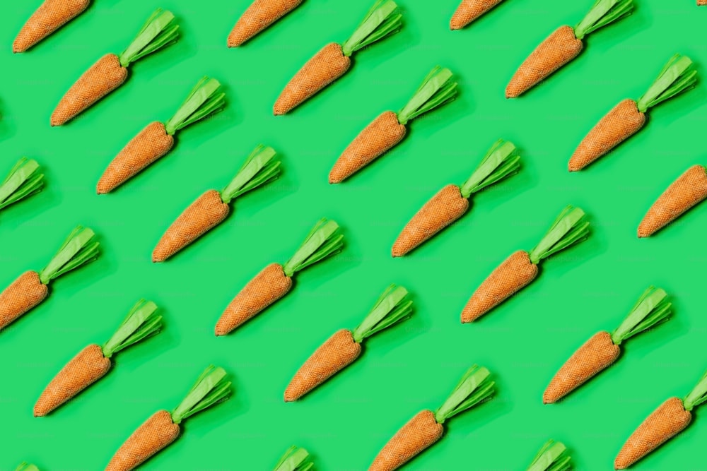 a pattern of carrots on a green background