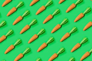 a pattern of carrots on a green background