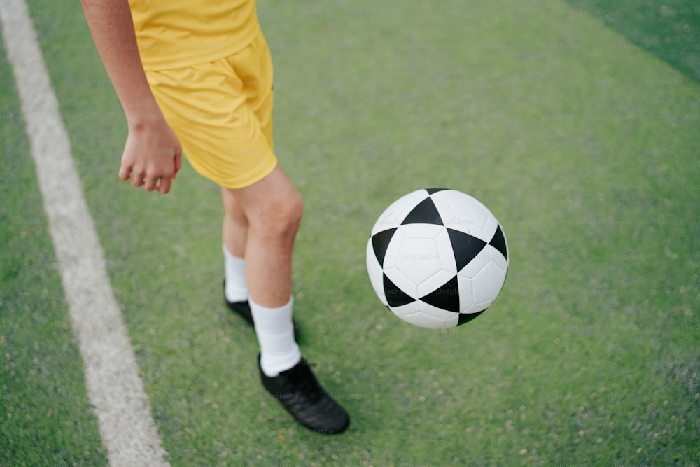 a soccer player is kicking a soccer ball