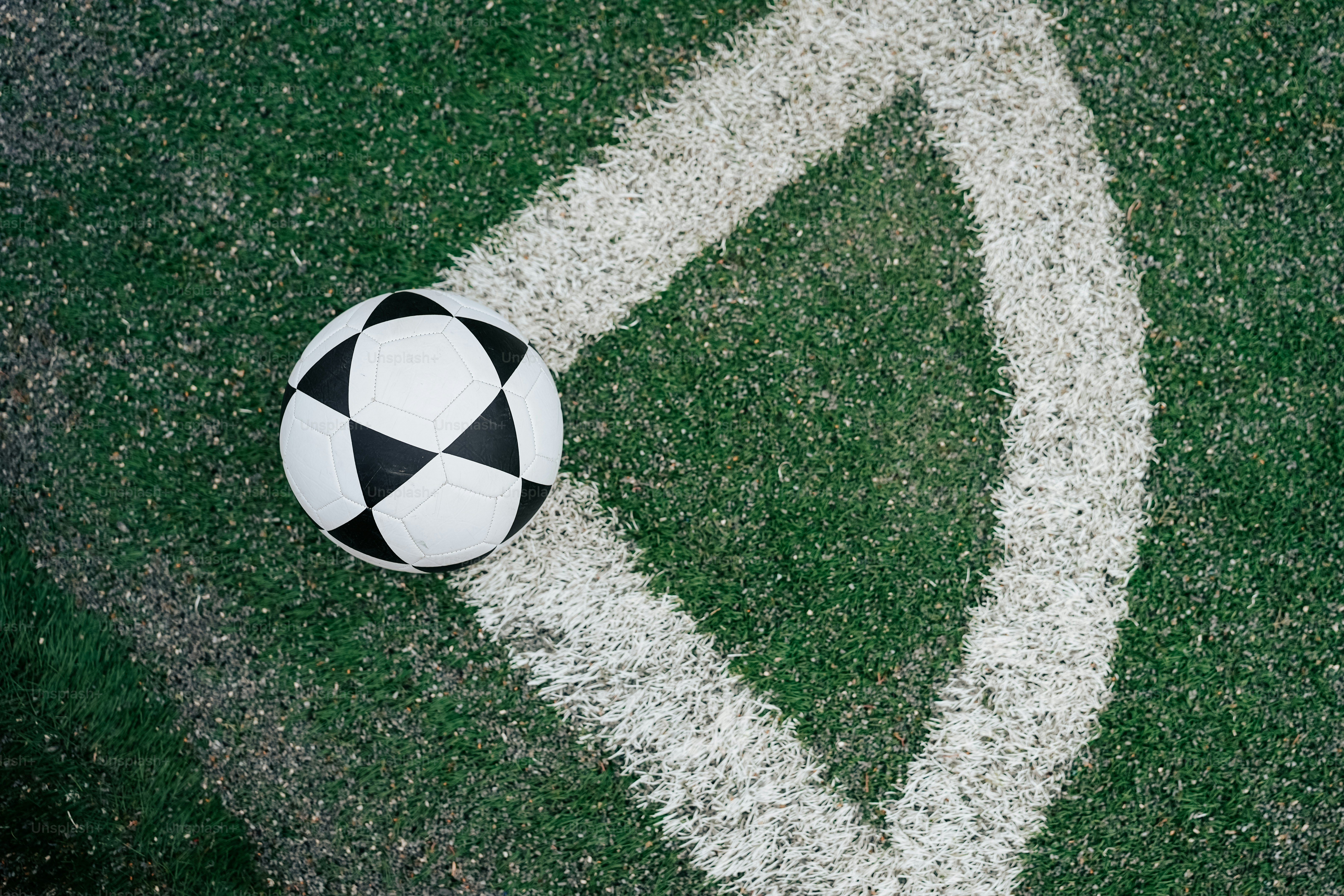 a soccer ball sitting on top of a green field