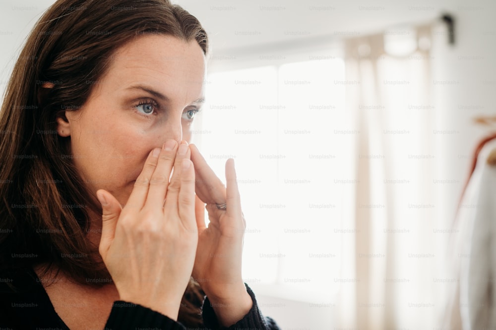 a woman covers her mouth with her hands