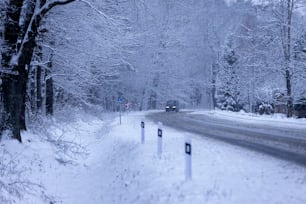 a car driving down a snow covered road