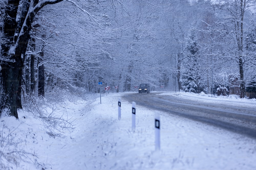 a car driving down a snow covered road