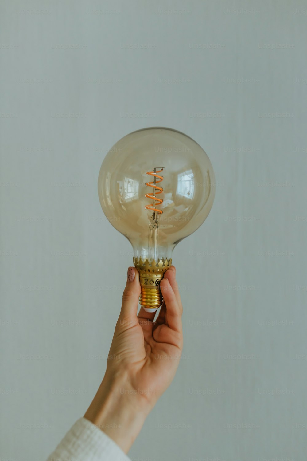 a person holding a light bulb in their hand