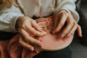 a close up of a person working on a piece of cloth