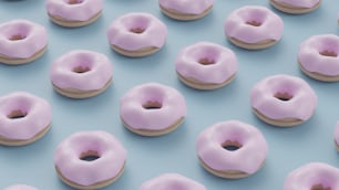 a group of pink donuts sitting on top of a blue surface