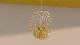 a birdcage filled with golden candles hanging from a ceiling