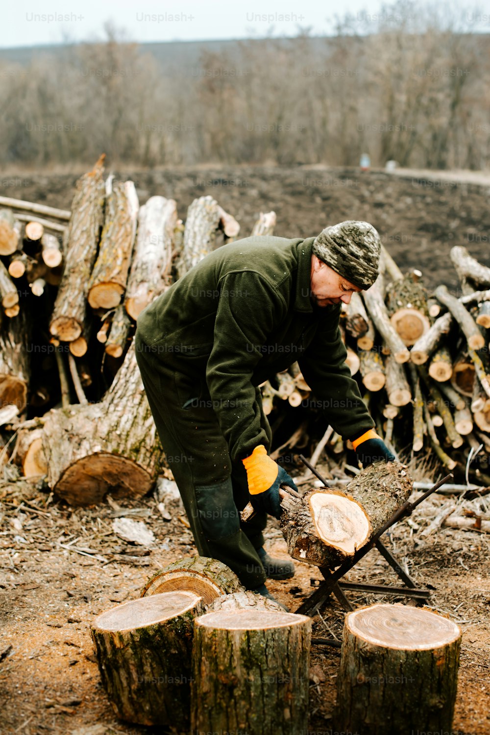 Ein Mann hackt Holz mit einer Kettensäge