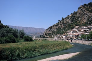 a river running through a lush green hillside