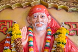 a statue of a man with flowers around his neck