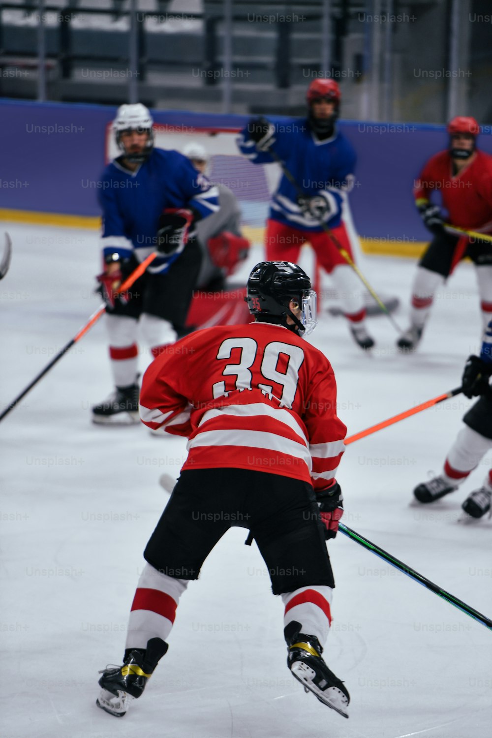 a group of young men playing a game of ice hockey