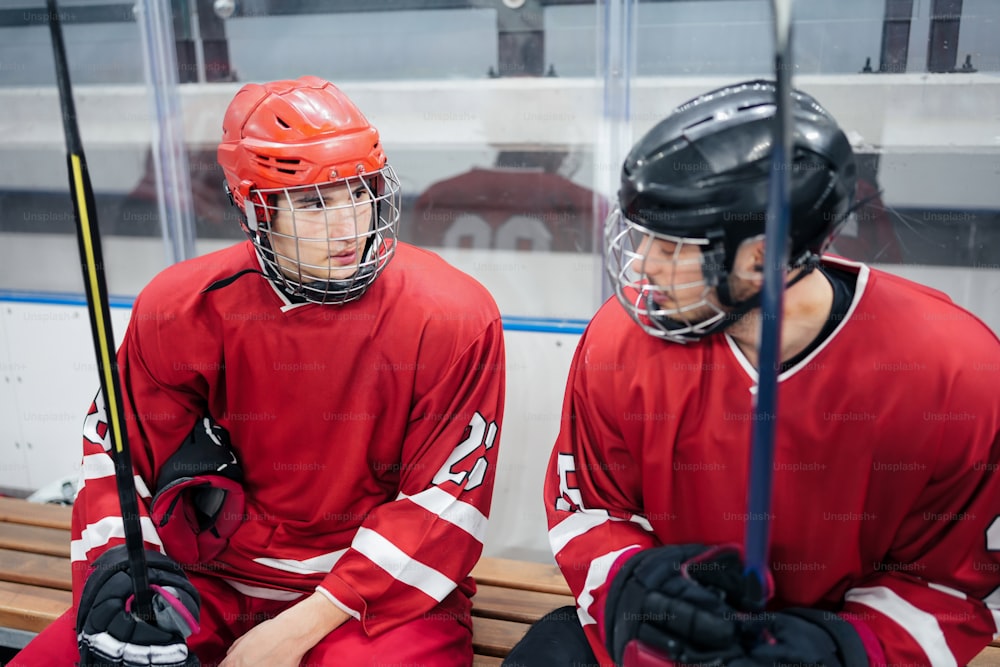 a couple of men sitting on top of a bench