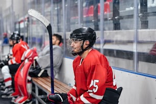 a group of hockey players sitting on a bench